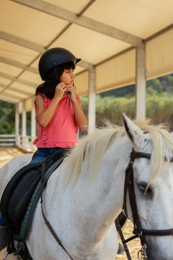 full-shot-girl-learning-ride-horse